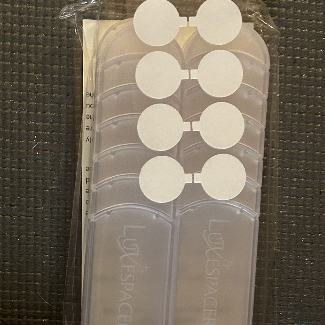 Luxespacer translucent spacers packaged with felt pads and the Luxespacer disclosure card